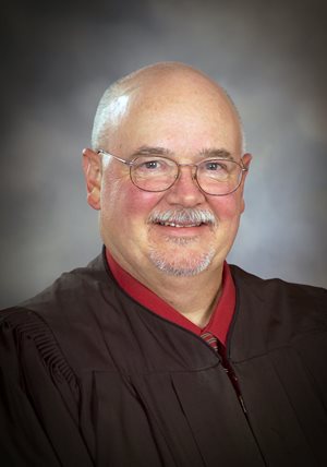 District Magistrate Judge Thomas M. Saxton Jr.